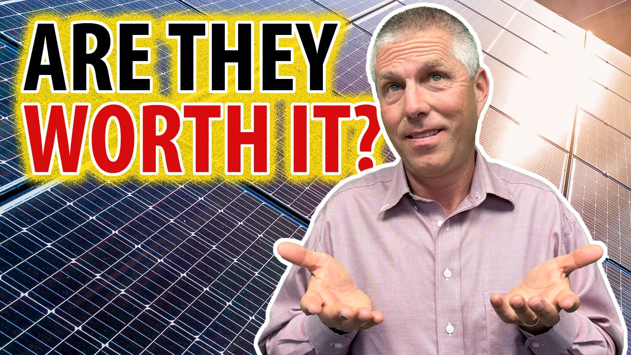 Chuck in front of solar panels with words Are they worth it